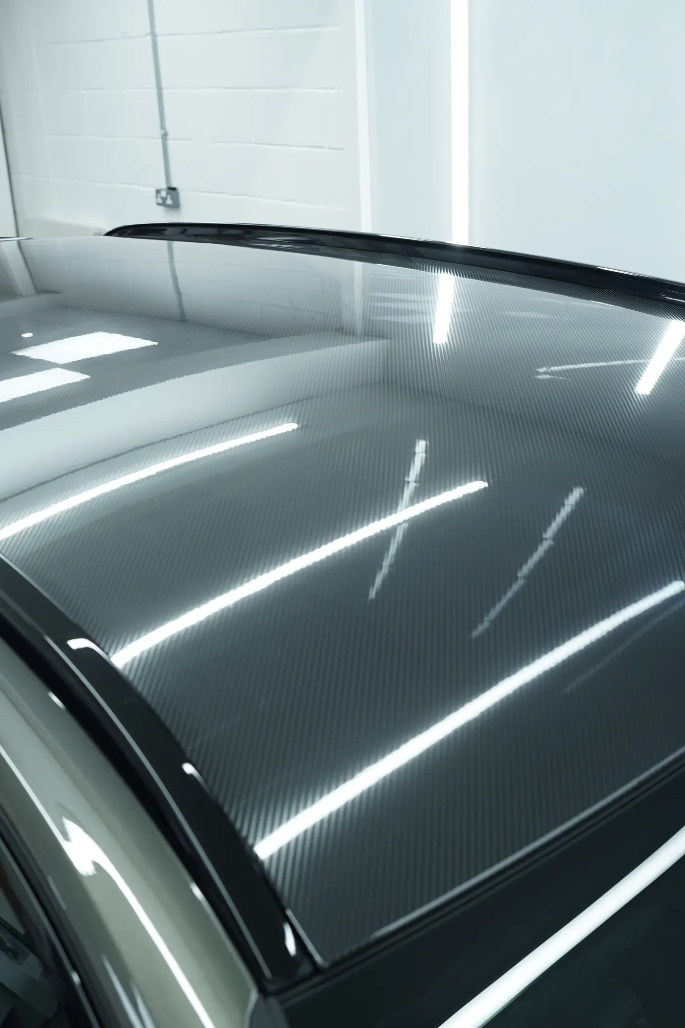 Carbon-effect paint protection film applied to a vehicle accent panel